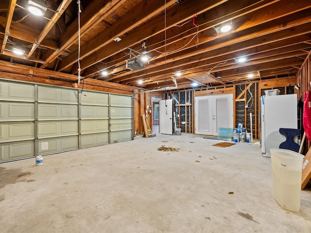garage with freestanding refrigerator and a garage door opener