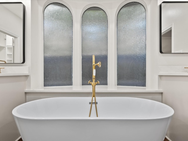 bathroom with a freestanding bath and vanity