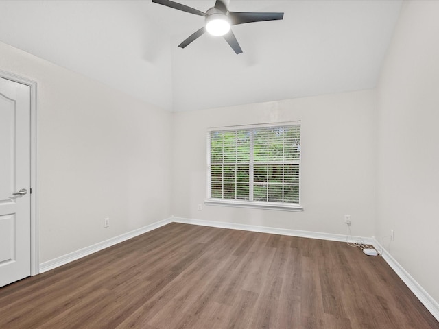 spare room featuring vaulted ceiling, wood finished floors, a ceiling fan, and baseboards