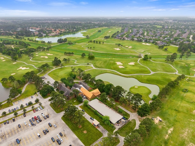 aerial view of property's location with a large body of water and a golf course