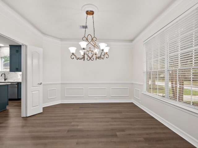 unfurnished dining area with a chandelier, dark wood-style floors, and crown molding