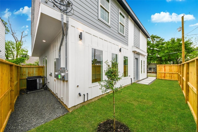 4601 White Rock St, Houston, TX 77051 - view of property exterior featuring central AC, board and batten siding, a fenced backyard, and a yard