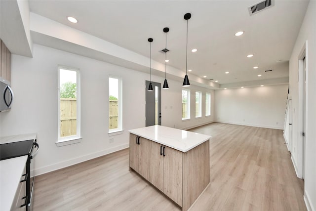 4601 White Rock St, Houston, TX 77051 - kitchen with light brown cabinets, a center island, a wealth of natural light, visible vents, and modern cabinets