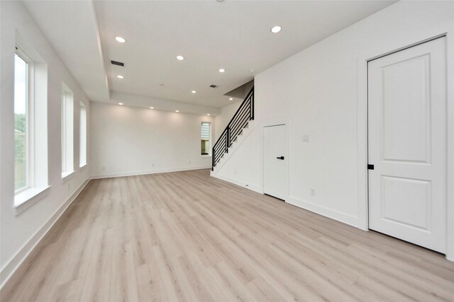 4601 White Rock St, Houston, TX 77051 - unfurnished living room with visible vents, baseboards, recessed lighting, light wood finished floors, and stairs