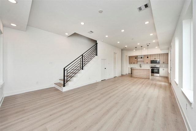 4601 White Rock St, Houston, TX 77051 - unfurnished living room featuring visible vents, light wood-style flooring, and recessed lighting
