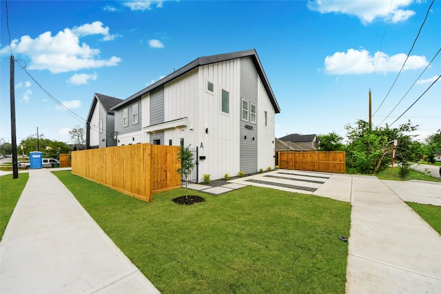 4601 White Rock St, Houston, TX 77051 - view of property exterior featuring board and batten siding, fence, and a yard