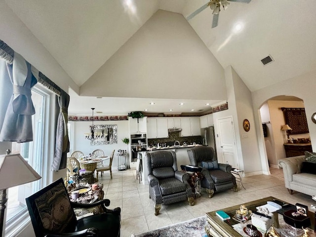 2914 Renoir, Sugar Land, TX 77479 - living room with arched walkways, a ceiling fan, light tile patterned flooring, high vaulted ceiling, and recessed lighting