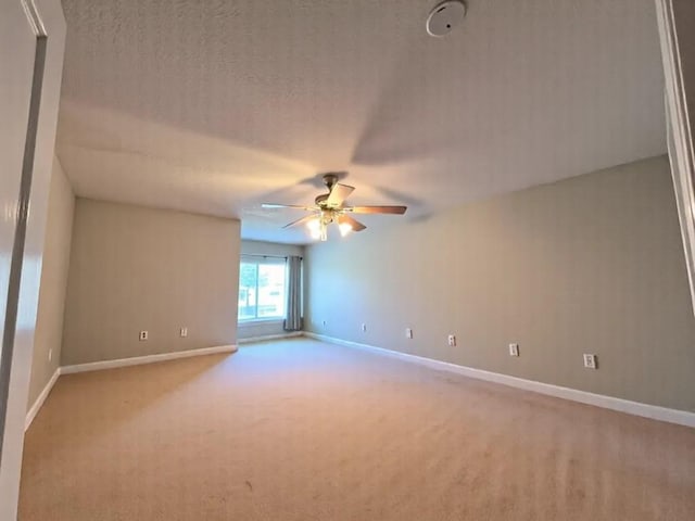 2914 Renoir, Sugar Land, TX 77479 - empty room with light carpet, a ceiling fan, baseboards, and a textured ceiling