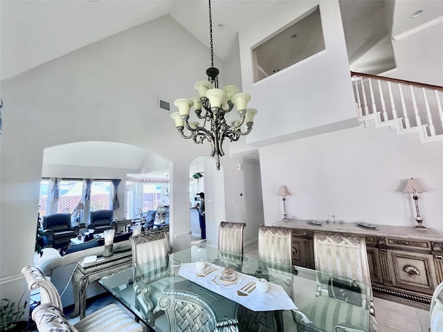 2914 Renoir, Sugar Land, TX 77479 - dining area with high vaulted ceiling, a chandelier, arched walkways, and baseboards