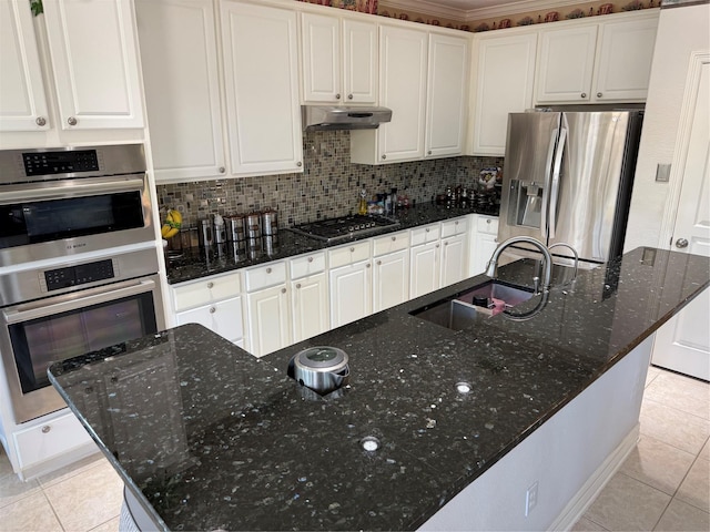 2914 Renoir, Sugar Land, TX 77479 - kitchen featuring stainless steel appliances, a sink, under cabinet range hood, light tile patterned floors, and white cabinetry