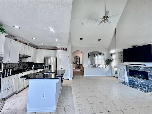 2914 Renoir, Sugar Land, TX 77479 - kitchen with open floor plan, stainless steel fridge, dark countertops, a ceiling fan, and under cabinet range hood