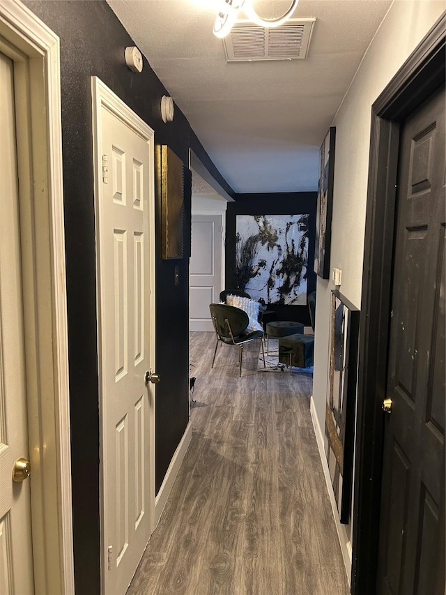 corridor featuring dark wood-style flooring