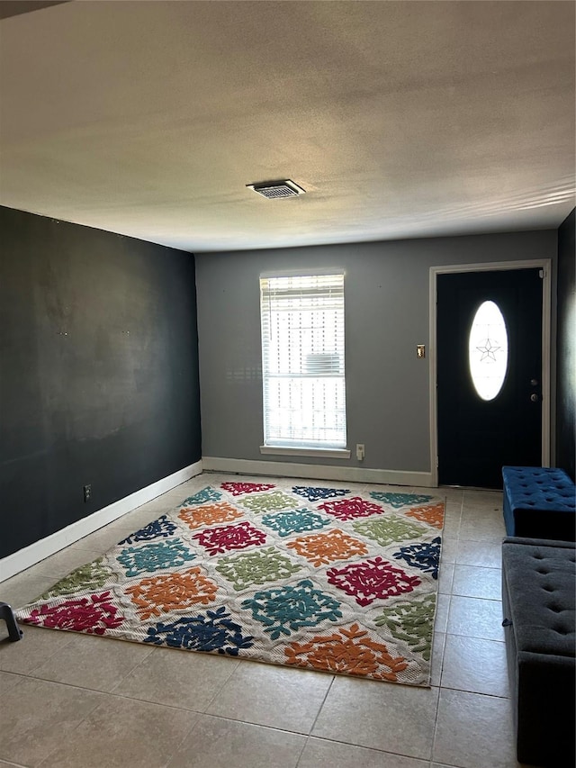 entryway featuring tile patterned flooring and baseboards