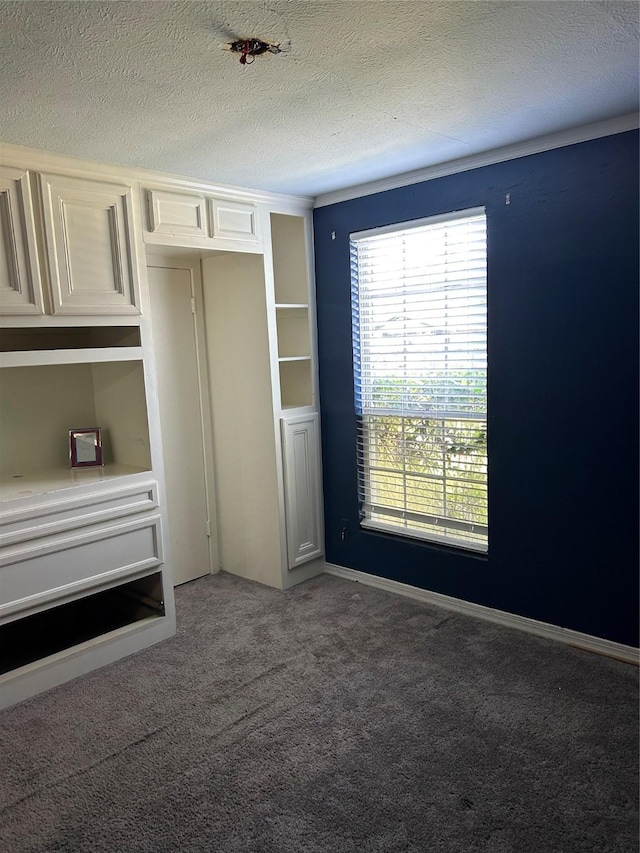 unfurnished bedroom featuring carpet floors and a textured ceiling