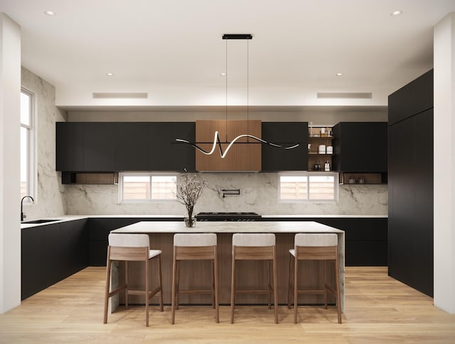 963 W 41st St, Houston, TX 77018 - kitchen featuring dark cabinets, a sink, a center island, and modern cabinets