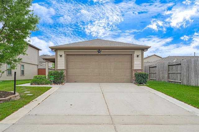 view of front of property with driveway, a garage, fence, and a front yard