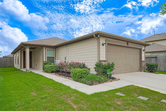 view of side of home with a lawn, driveway, fence, and an attached garage