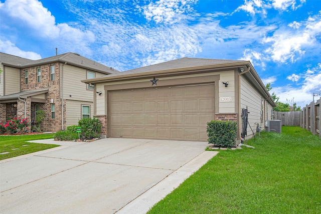 view of front of property with driveway, a front yard, fence, brick siding, and central AC unit