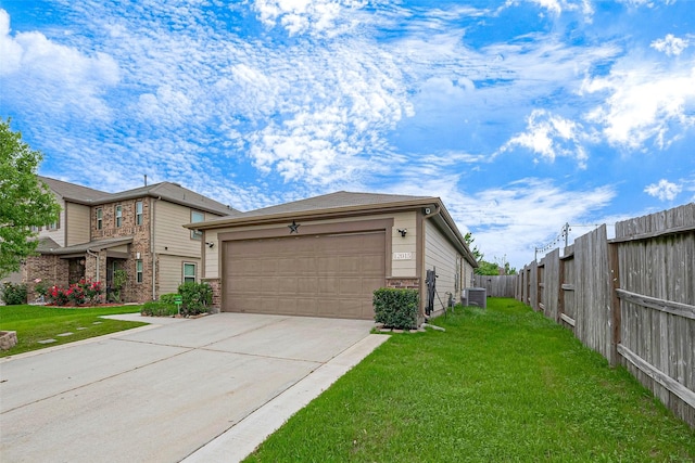 exterior space with central AC unit, fence, a garage, concrete driveway, and a lawn