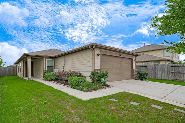 view of side of property featuring fence, a lawn, driveway, and an attached garage