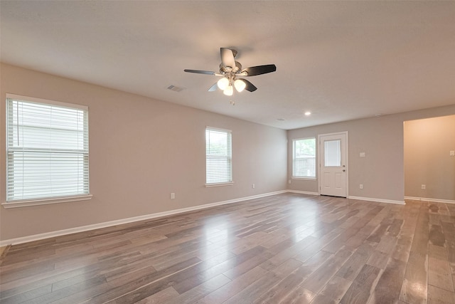 spare room with a ceiling fan, wood finished floors, baseboards, visible vents, and recessed lighting