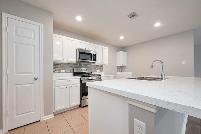 kitchen featuring a sink, white cabinetry, visible vents, and appliances with stainless steel finishes