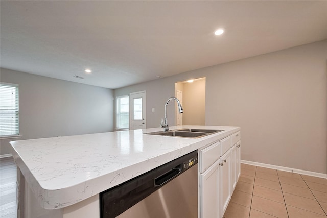 kitchen featuring baseboards, a sink, dishwasher, white cabinets, and a kitchen island with sink