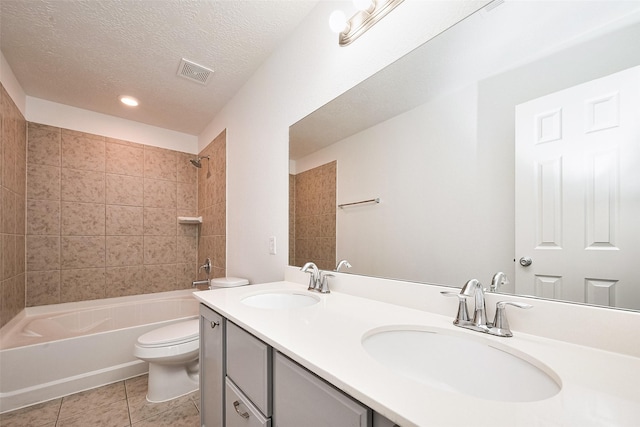 bathroom with toilet, a sink, tile patterned floors, and visible vents