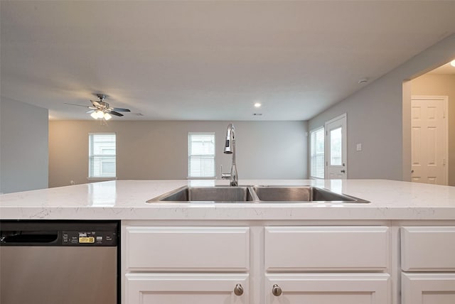 kitchen featuring white cabinets, a sink, ceiling fan, and stainless steel dishwasher