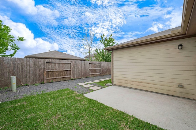 view of yard with a fenced backyard and a patio
