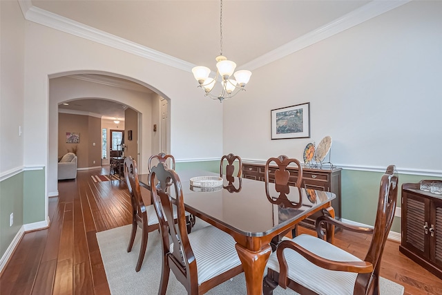 14515 Basalt Ln, Houston, TX 77077 - dining area featuring a chandelier, arched walkways, and crown molding