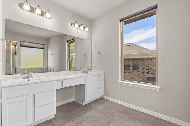 32734 Harvest Valley Dr, Brookshire, TX 77423 - bathroom with baseboards, double vanity, tile patterned flooring, and a shower with shower door