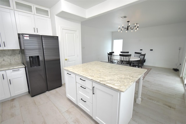 42 County Road 5102l, Cleveland, TX 77327 - kitchen featuring stainless steel fridge with ice dispenser, a chandelier, white cabinetry, and a kitchen island