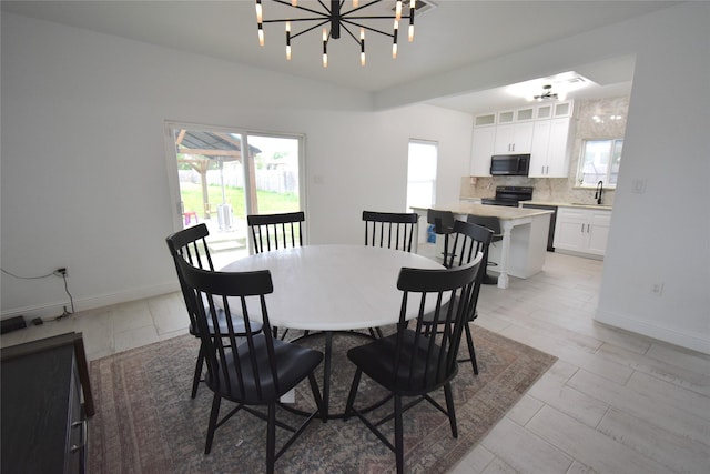 42 County Road 5102l, Cleveland, TX 77327 - dining area with a chandelier and baseboards