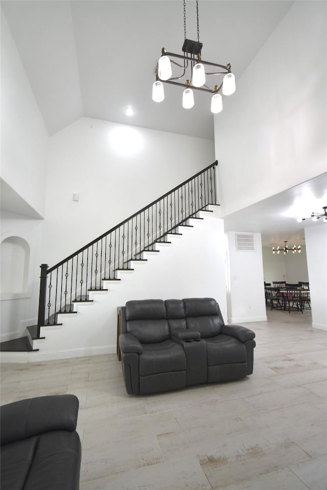 42 County Road 5102l, Cleveland, TX 77327 - living area featuring high vaulted ceiling, a chandelier, stairway, and baseboards