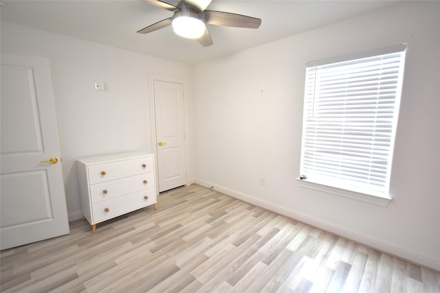 42 County Road 5102l, Cleveland, TX 77327 - unfurnished bedroom featuring light wood-type flooring, baseboards, and ceiling fan