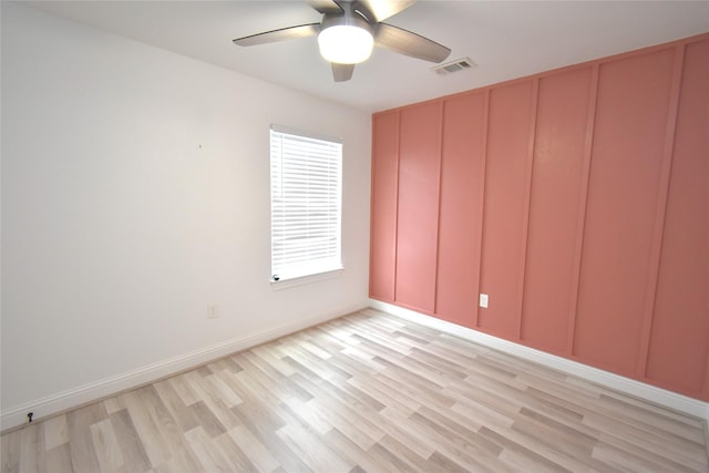 42 County Road 5102l, Cleveland, TX 77327 - spare room featuring ceiling fan, light wood-type flooring, a decorative wall, and baseboards