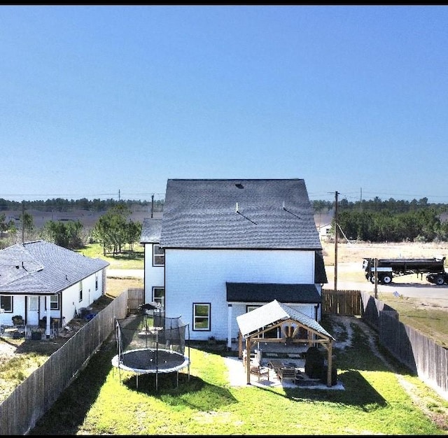42 County Road 5102l, Cleveland, TX 77327 - rear view of house with a gazebo and a trampoline