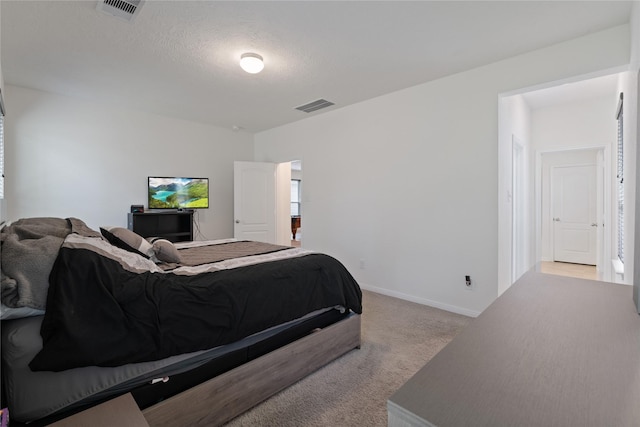 bedroom featuring carpet floors, visible vents, and baseboards