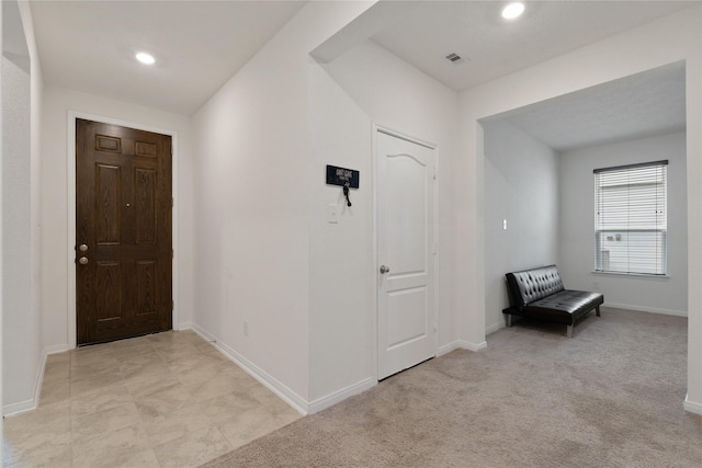 foyer featuring baseboards, visible vents, and recessed lighting