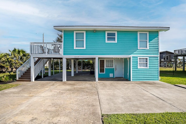 16519 Mansvelt Rd, Jamaica Beach, TX 77554 - view of front of property featuring driveway, a carport, and stairway