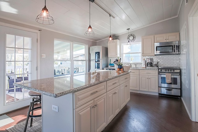 16519 Mansvelt Rd, Jamaica Beach, TX 77554 - kitchen featuring dark wood finished floors, tasteful backsplash, ornamental molding, and appliances with stainless steel finishes