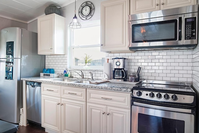 16519 Mansvelt Rd, Jamaica Beach, TX 77554 - kitchen featuring light stone counters, a sink, stainless steel appliances, white cabinets, and decorative backsplash