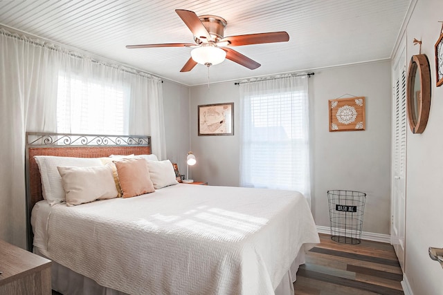 16519 Mansvelt Rd, Jamaica Beach, TX 77554 - bedroom featuring multiple windows, wood finished floors, ceiling fan, and baseboards