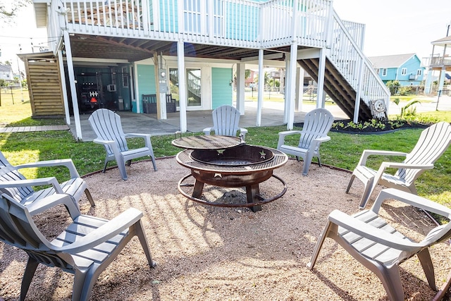 16519 Mansvelt Rd, Jamaica Beach, TX 77554 - view of patio / terrace with a fire pit, stairway, and a wooden deck