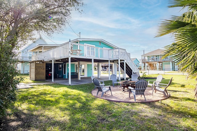 16519 Mansvelt Rd, Jamaica Beach, TX 77554 - rear view of property with an outdoor fire pit, a deck, a patio area, and a yard