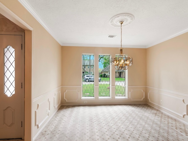 16707 Rugby Ct, Spring, TX 77379 - entrance foyer with a chandelier, a textured ceiling, ornamental molding, and wainscoting