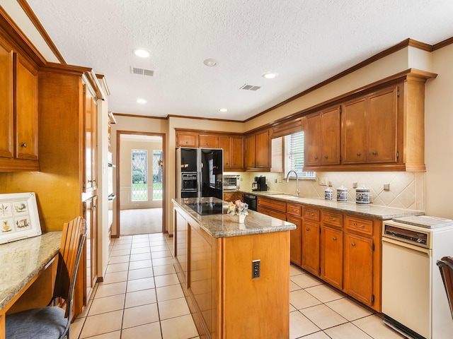16707 Rugby Ct, Spring, TX 77379 - kitchen featuring black appliances, a center island, decorative backsplash, ornamental molding, and a sink
