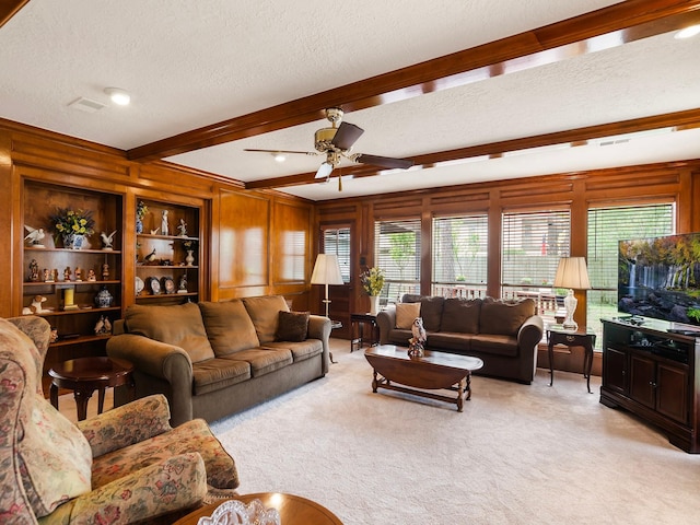 16707 Rugby Ct, Spring, TX 77379 - living room featuring a ceiling fan, beamed ceiling, light carpet, a textured ceiling, and healthy amount of natural light