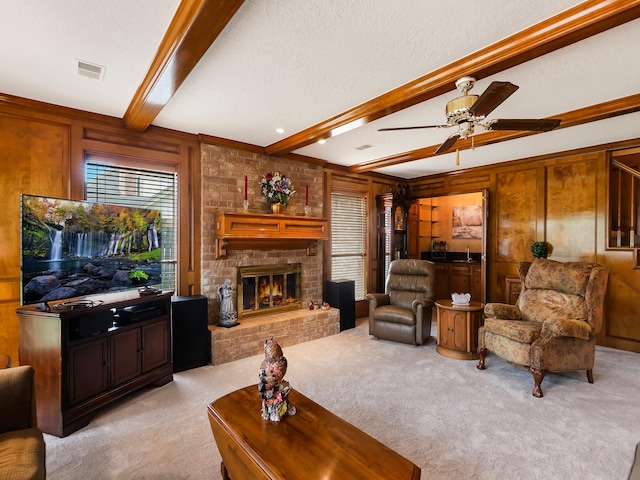 16707 Rugby Ct, Spring, TX 77379 - living room with light carpet, beam ceiling, ceiling fan, a fireplace, and wooden walls
